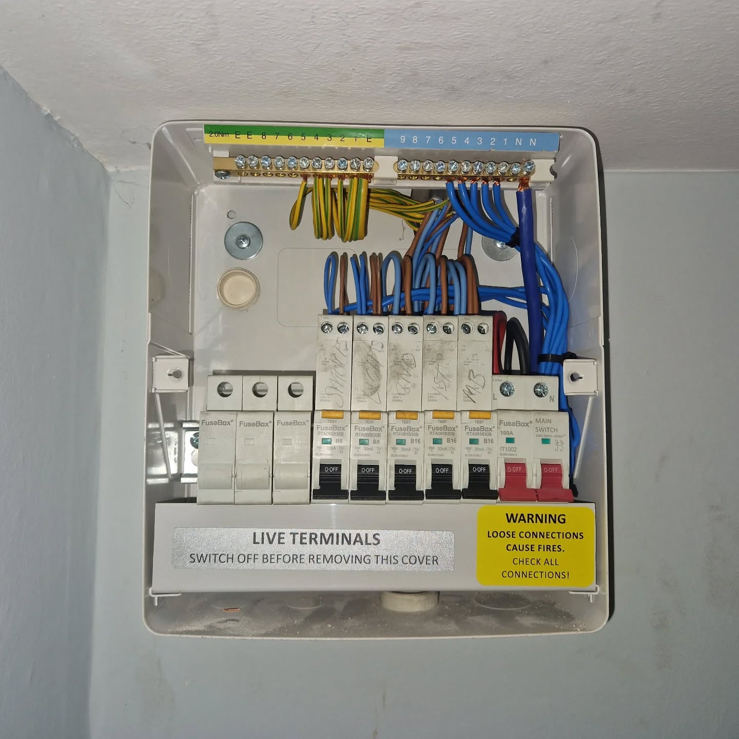 Domestic fuse box with safety switches and colorful wired connections