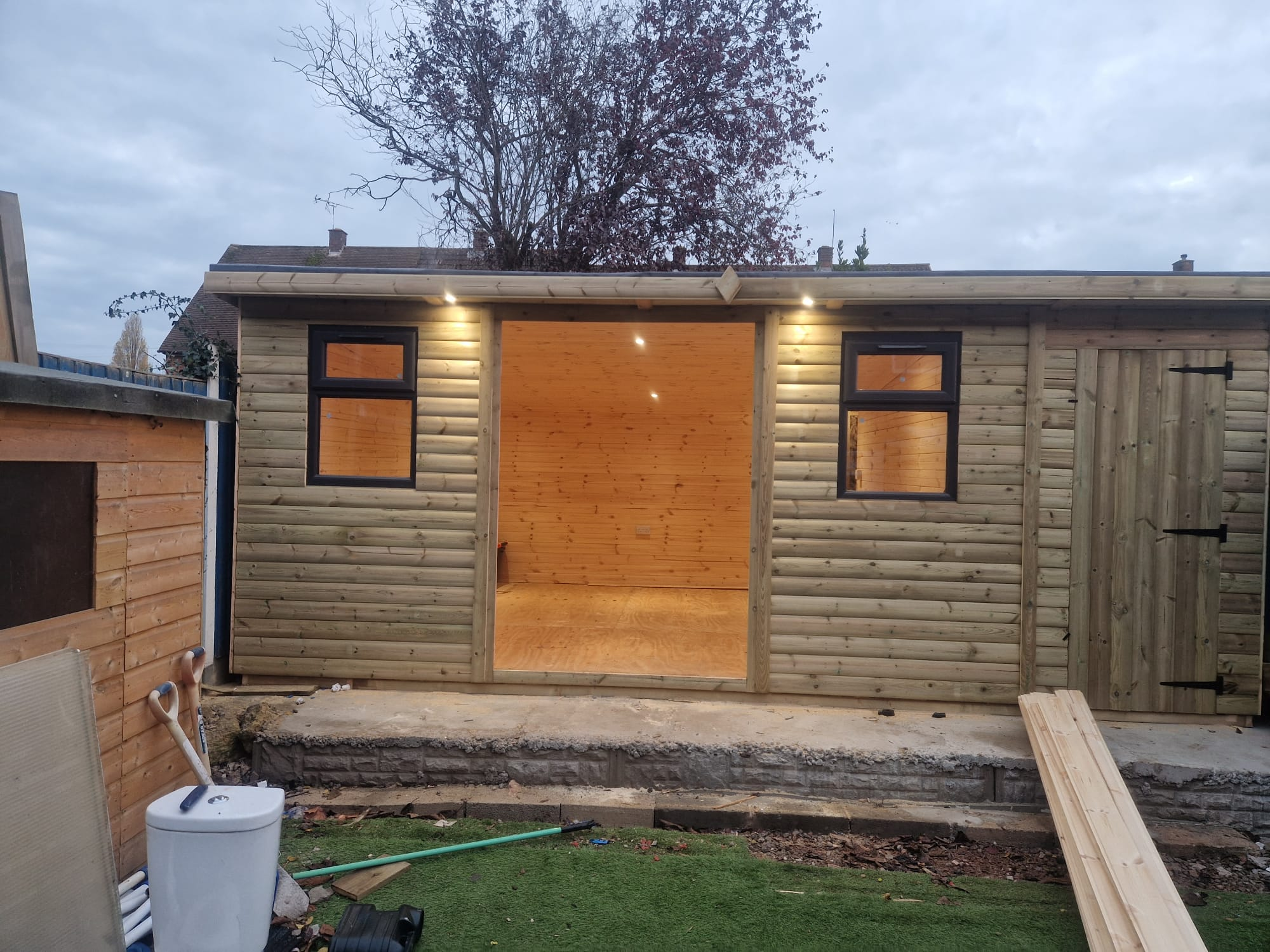 Modern garden shed interior with LED strip lights and wooden walls